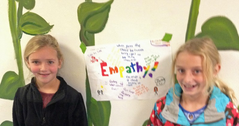 Two students with empathy poster.